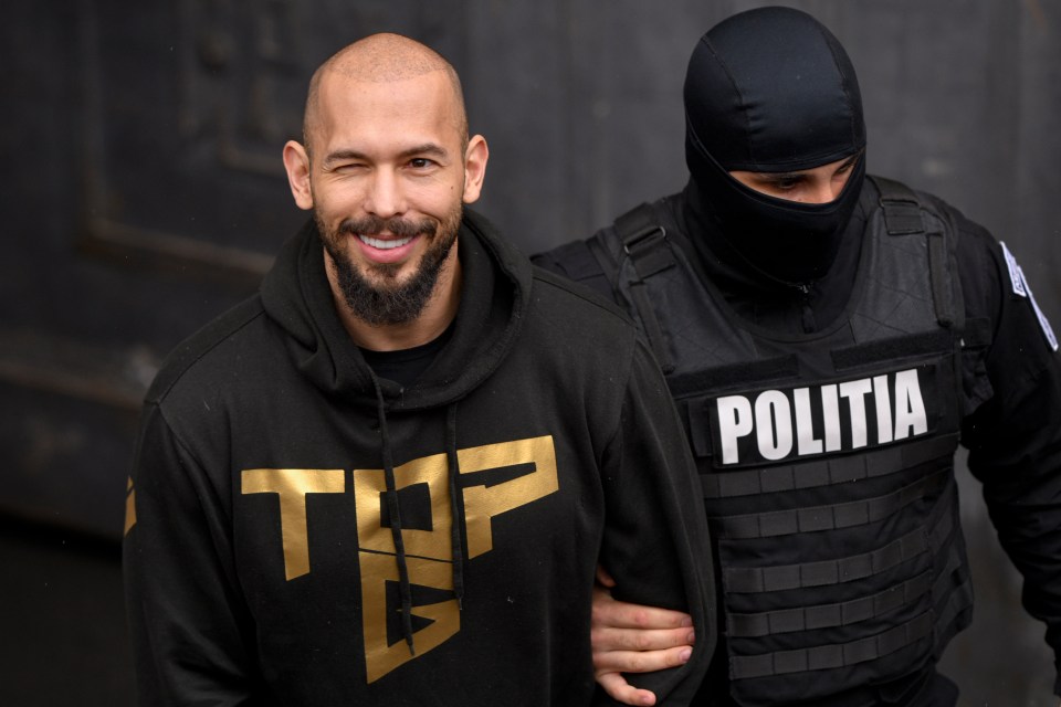 Tate smirking after their arrest in March after British police obtained a European arrest warrant