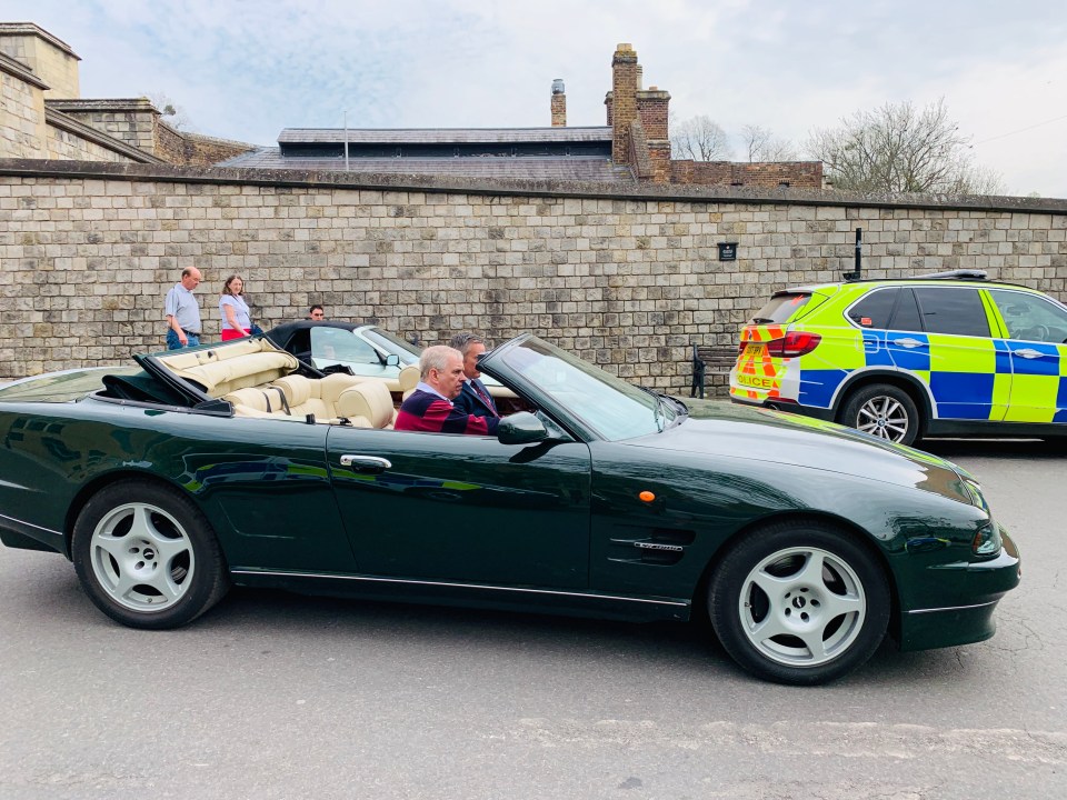 The disgraced prince is pictured driving out of Windsor castle in a vintage Aston Martin without wearing a seatbelt