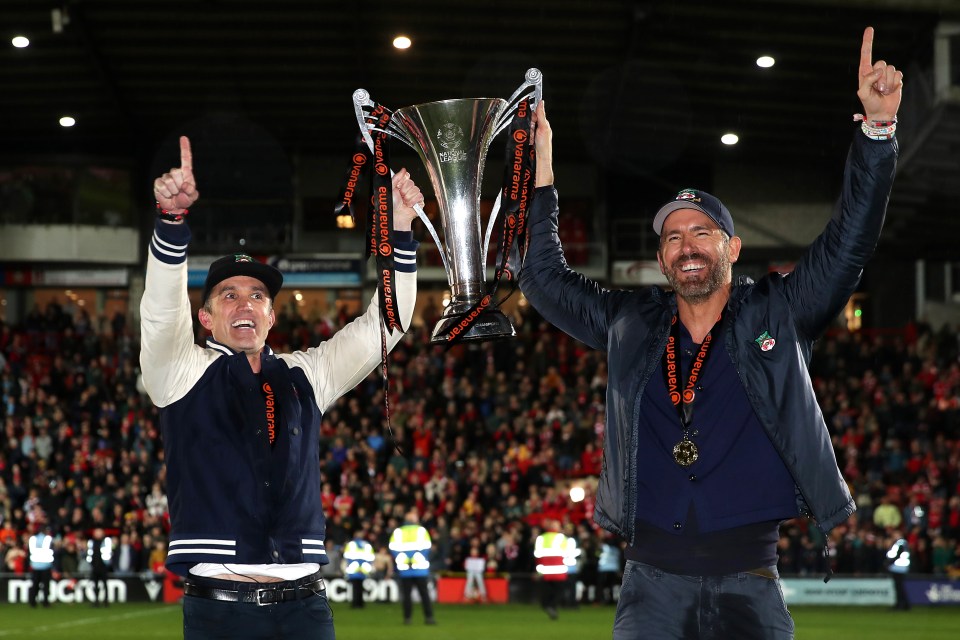 Ryan and Rob lifting the Vanarama National League trophy last year after Wrexham were promoted