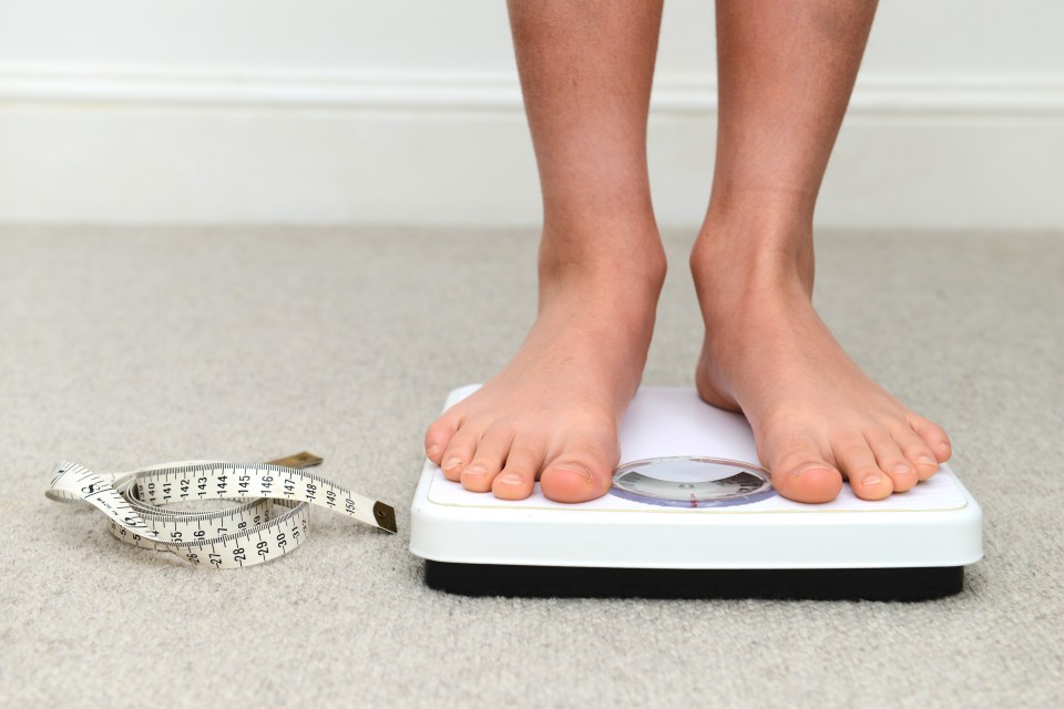 School boy on bathroom scales