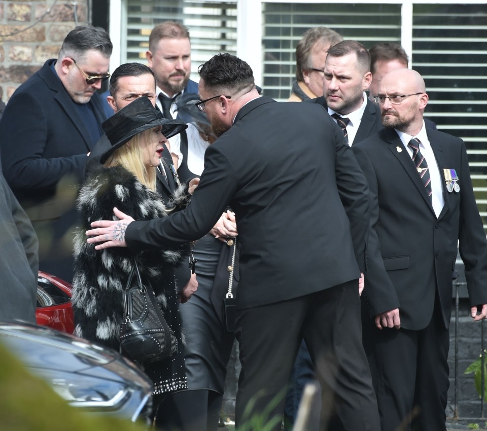 Tina could be seen being comforted by loved ones as she cut a sombre figure