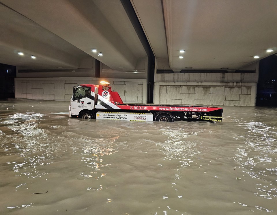 A submerged duty machine is seen after heavy rain in the UAE