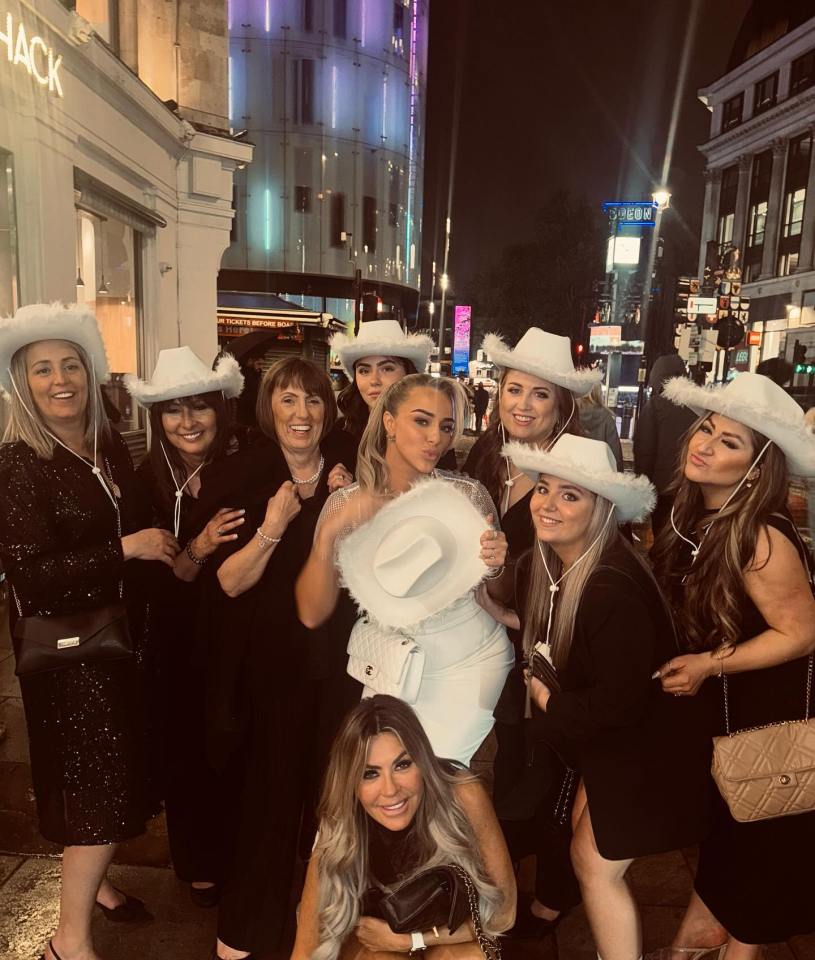 The group posed in white cowgirl hats