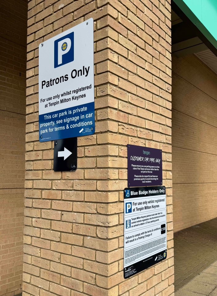 Two small signs are easily missed by motorists who are concentrating on parking safely