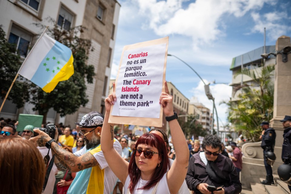 People carried banners complaining about mass tourism in the holiday hotspot