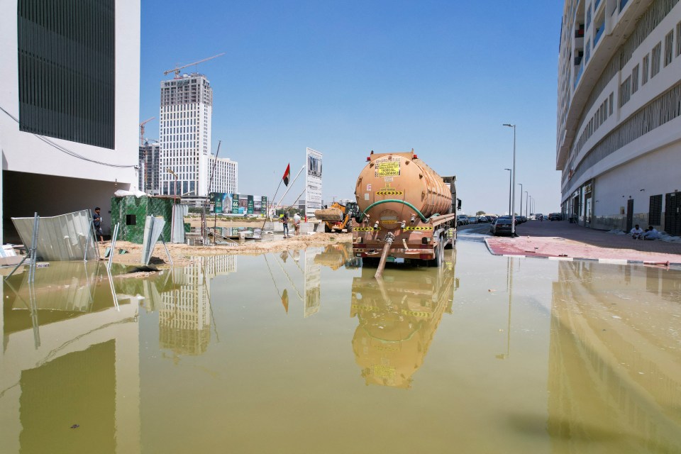 A recovery truck draining some of the floodwater away as Dubai waits for the true extent of the damage to be revealed