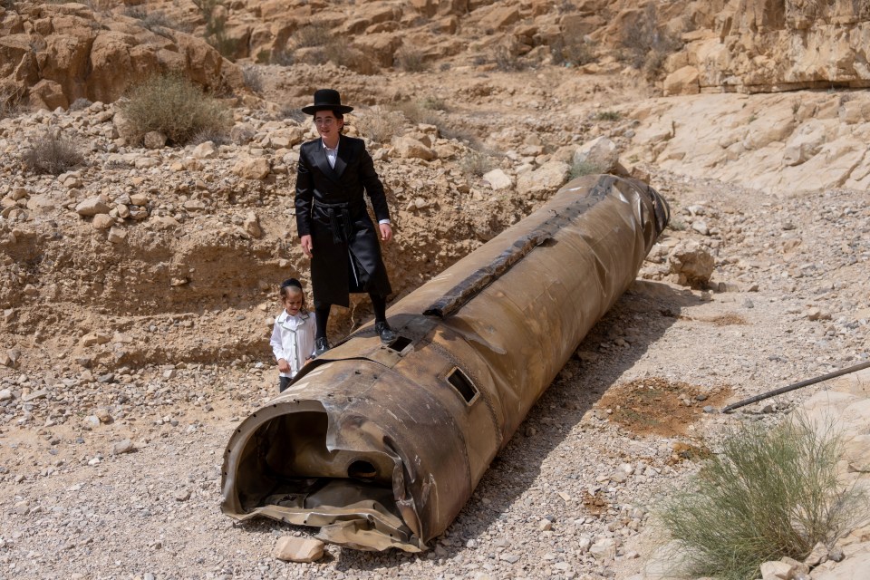 Israelis posing next to the down missiles