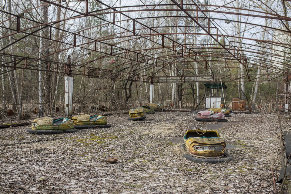 Here abandoned bumper cars have been left to rot in a deserted fairground in Chernobyl