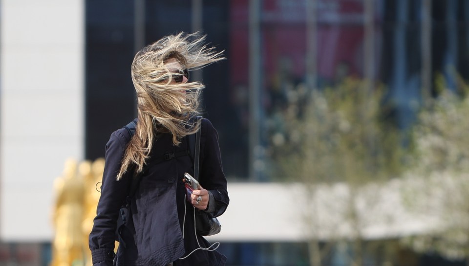 A woman struggling in the strong wind in Birmingham earlier this month