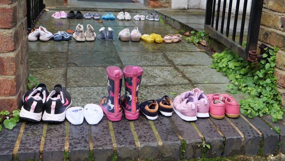 The activists placed several children's shoes all the way up to his front door