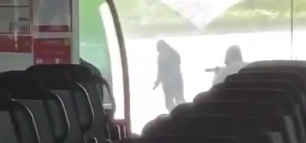 More video shows the armed gunmen, clad in black hoods and gloves, bracing to shoot at the police convoy