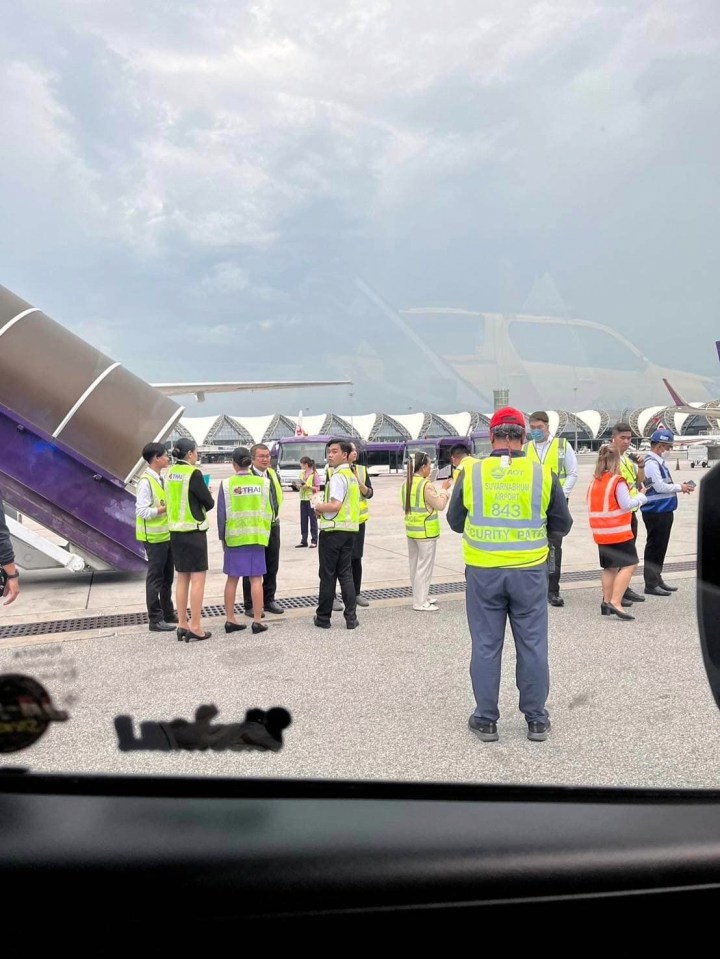 Staff outside the Singapore Airlines flight ready to help after the 'severe turbulence' left one dead and dozens injured