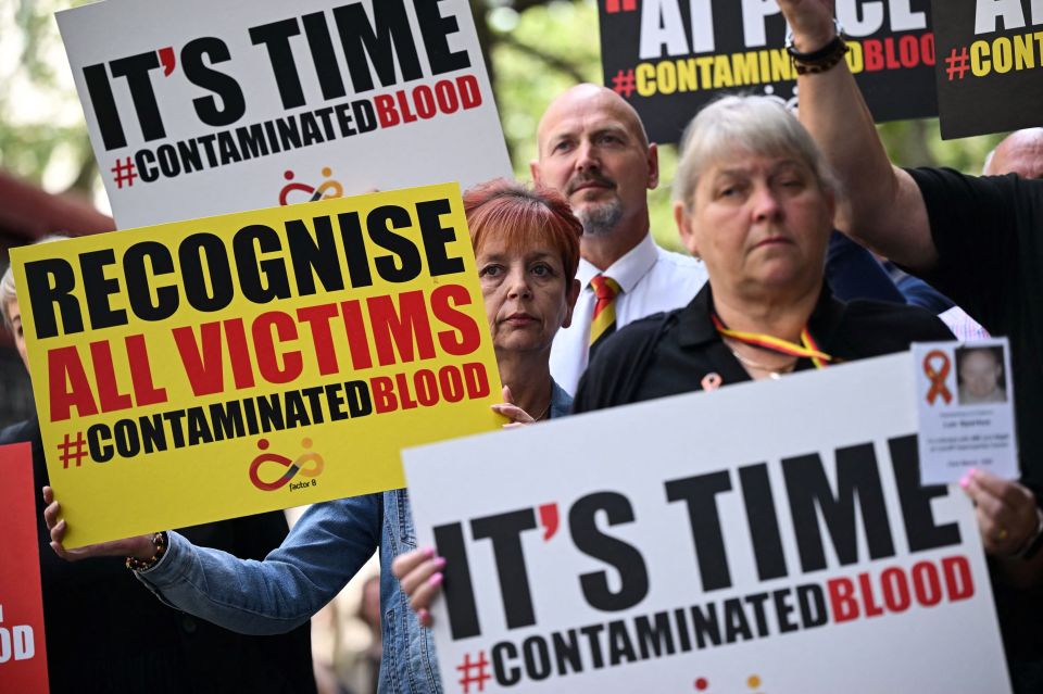 NHS infected blood scandal campaigners hold placards saying: 'It's time'