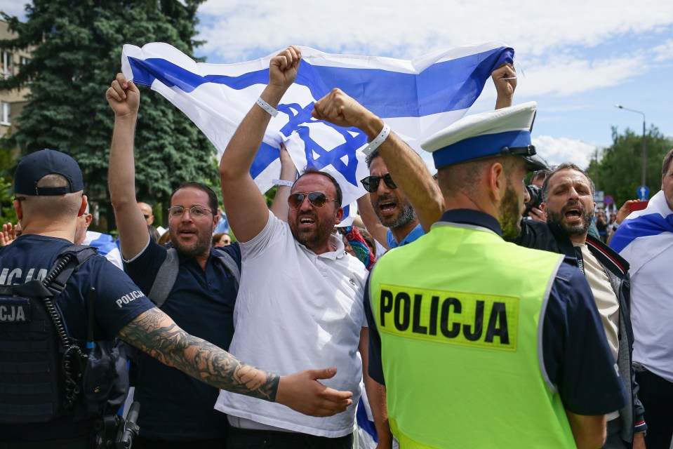 Police officers separate pro-Palestinian demonstrators from March of the Living participants at the site of the former Nazi death camp in Poland