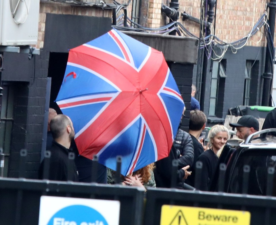 Mum and baby were shielded by a huge Union Jack umbrella