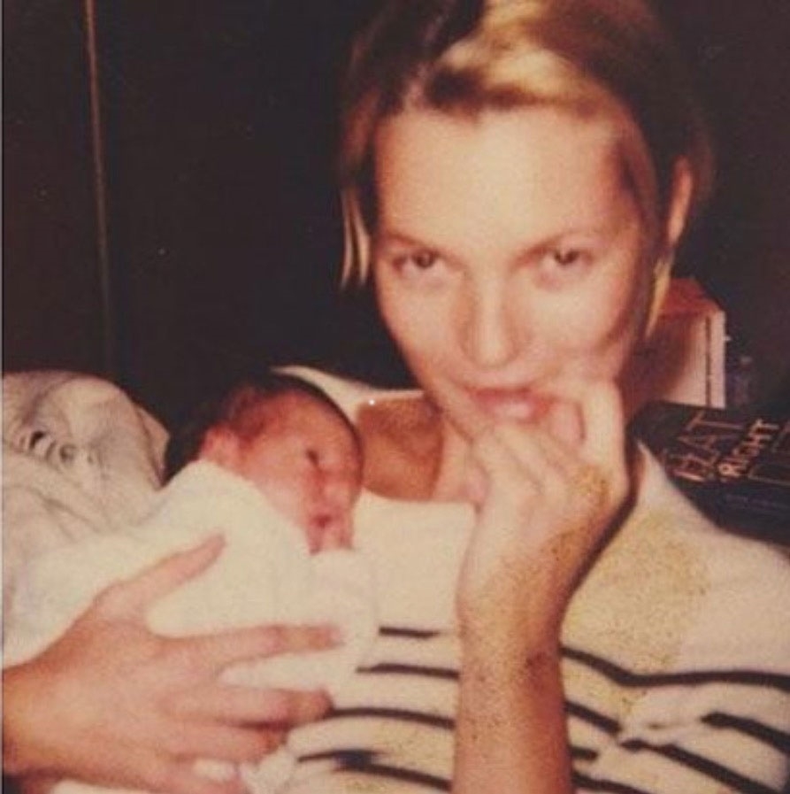 Iris' godmother Kate Moss holds her as a baby