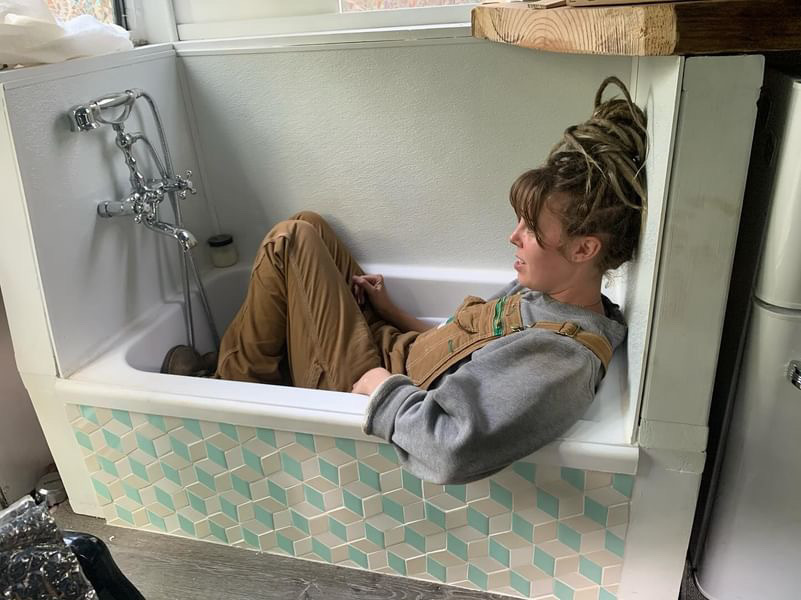 She has a bath tub on board her bus - and used 65-year-old tiles from her granny's house to decorate it