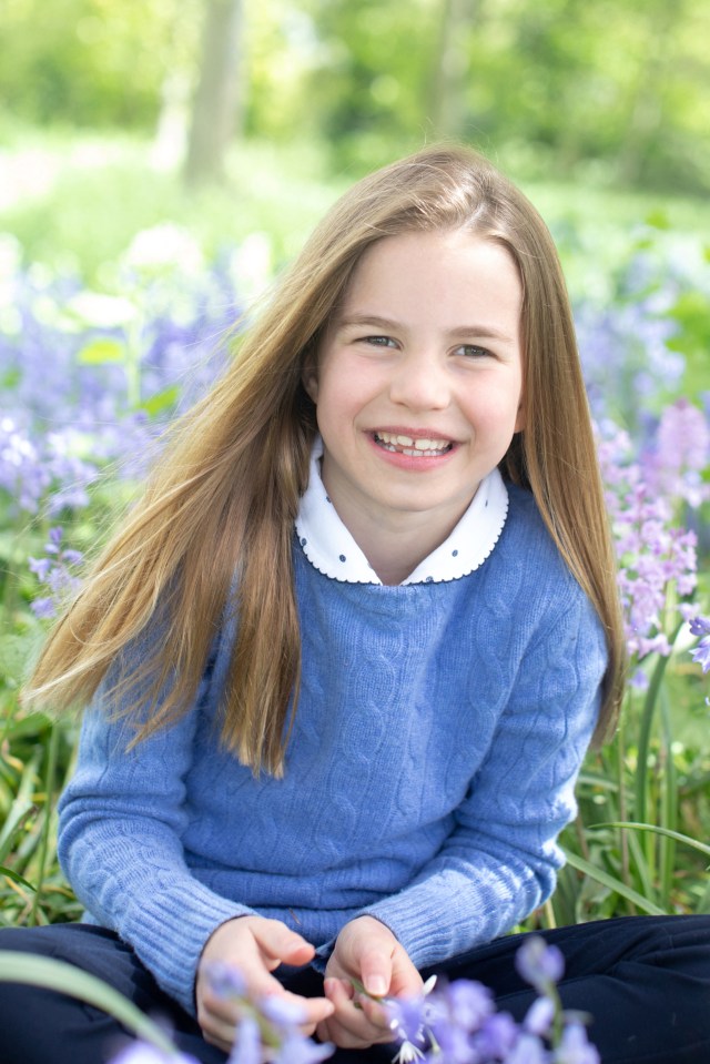 Charlotte beams in this photo showing her playing in bluebells for her seventh birthday