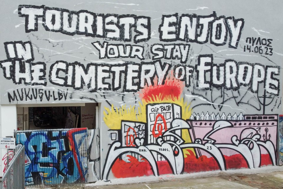 Another grafitti reads "Tourists Enjoy Your Stay In The Cemetery Of Europe"