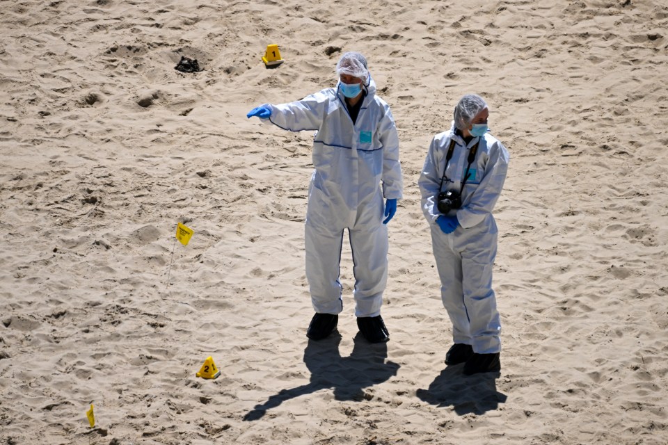 Forensics officers scoured the beach for clues as they opened a murder investigation on Saturday