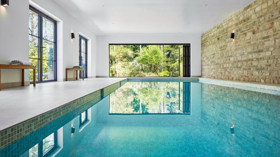 a large indoor swimming pool with a large window