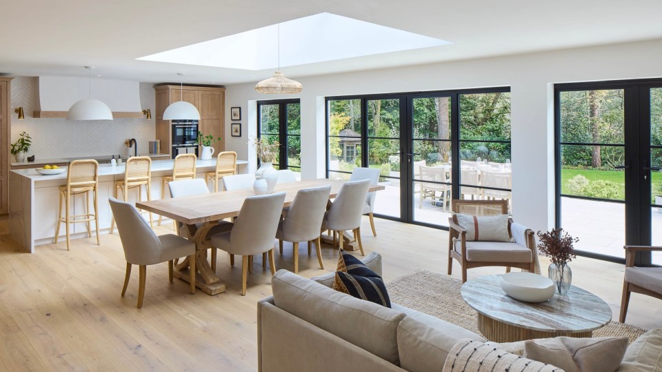 a living room with a dining table and chairs