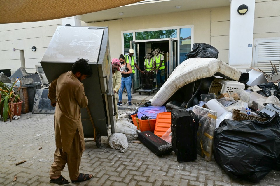 Workers cleaning up a flooded building in Dubai on May 1 after it was damaged in the floods