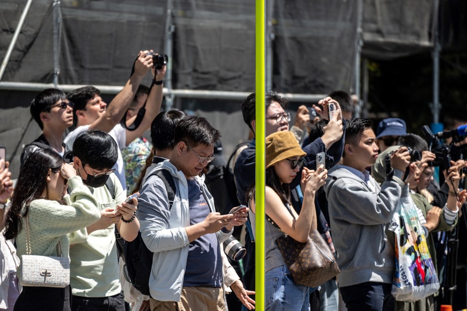 Tourists now stand in front of the fence attempting to take photos