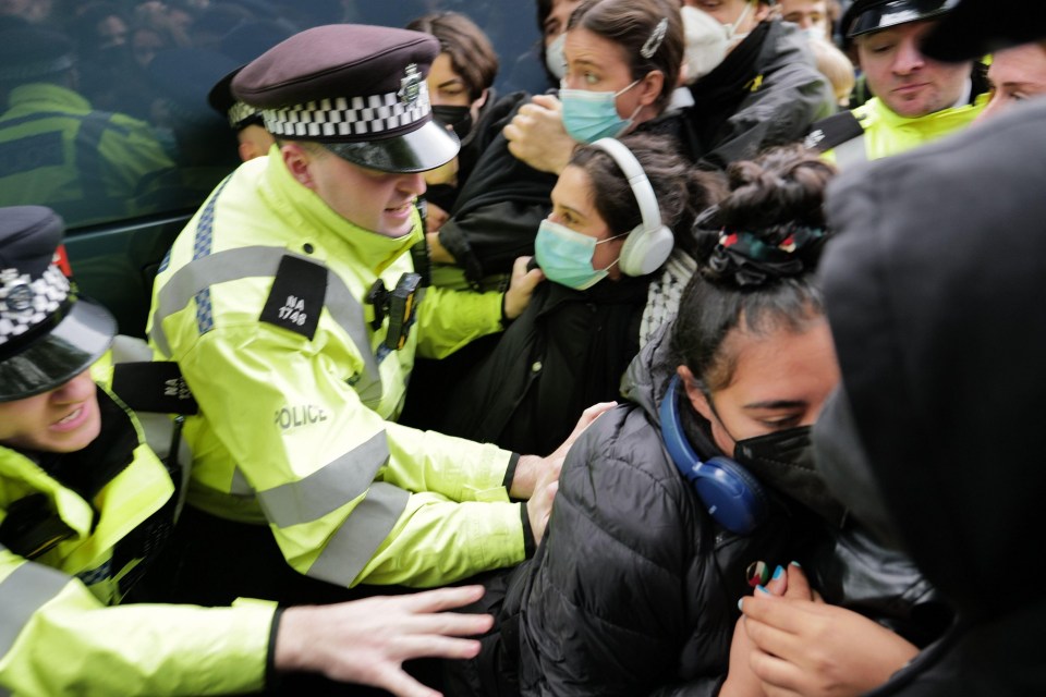 Police intervene as protesters stop a coach leaving the area