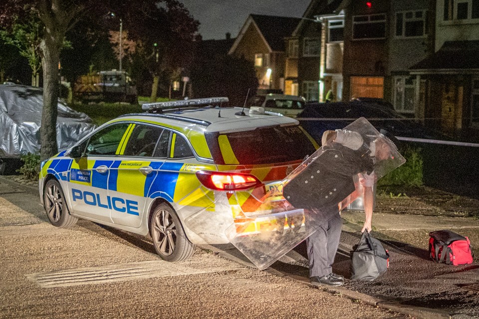 A police officer with a riot shield at the scene yesterday