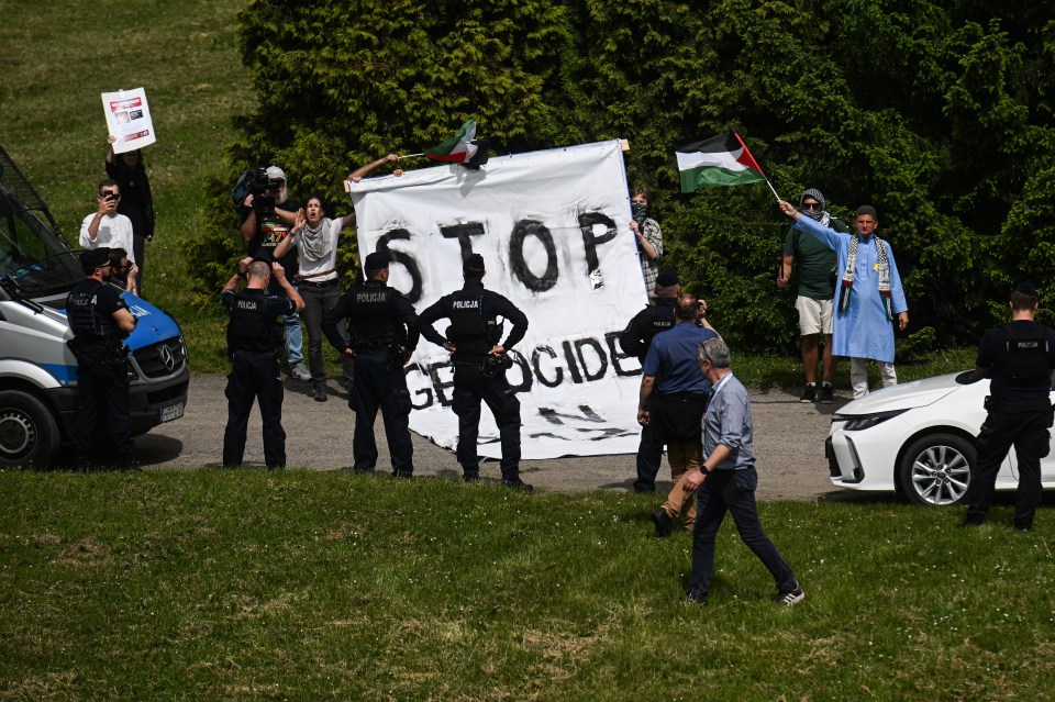 Pro Palestinian protesters hold a giant banner saying “stop the Genocide” near the former Nazi concentration death camp Auschwitz