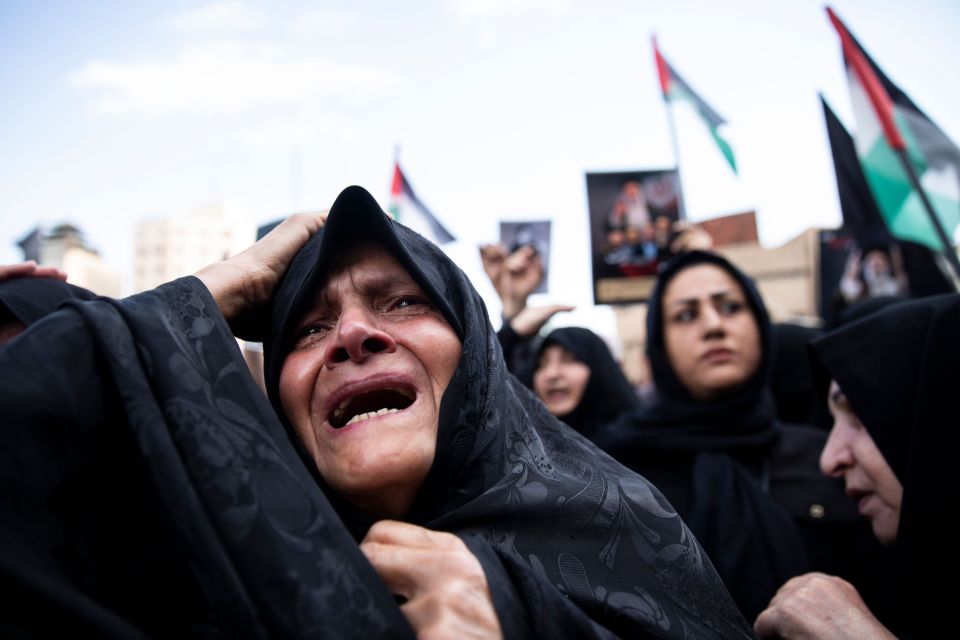 A woman weeps during a mourning ceremony for President Raisi at Vali-e-Asr Square in downtown Tehran on Monday