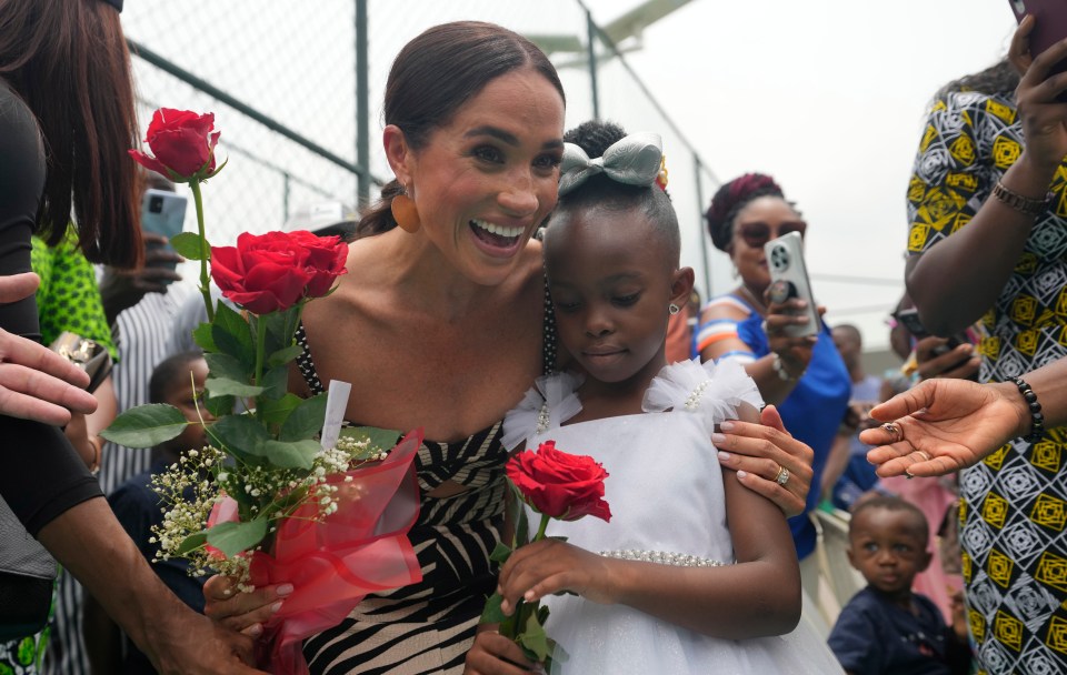 Meghan received flowers from a little girl while at the Nigerian army Defence HQ in Abuja on Saturday