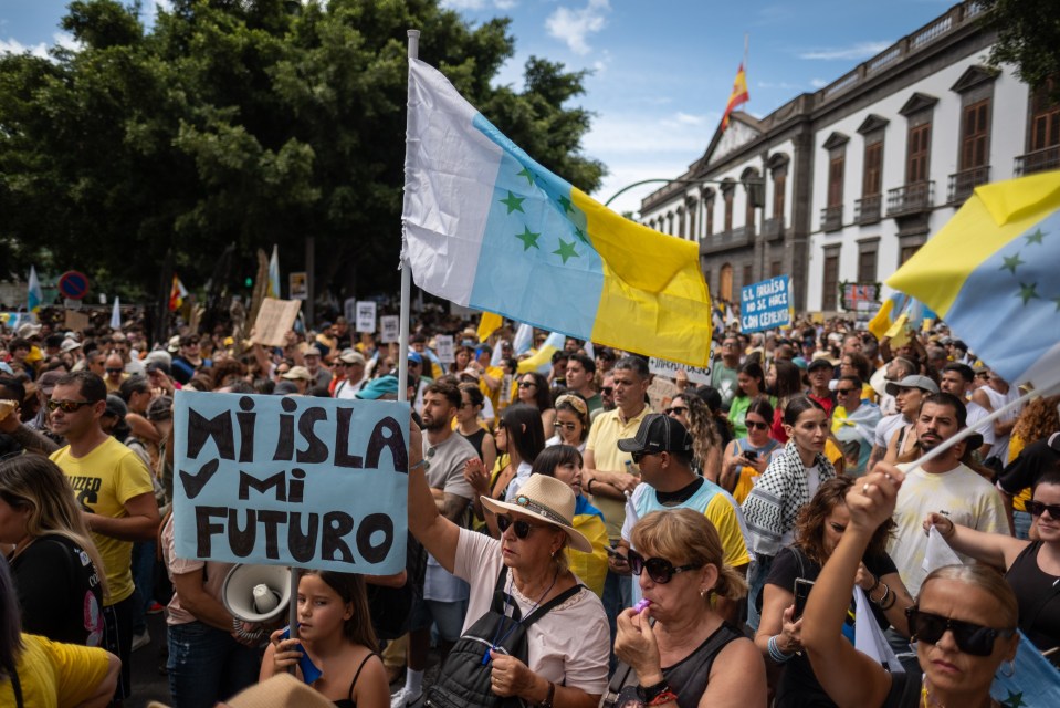 A sign in Spanish reads: 'My island, my future'