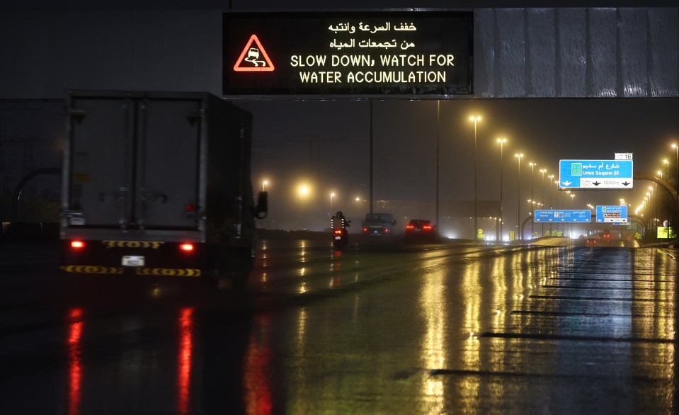 A road screen board alerts motorists of heavy rainfall in Dubai