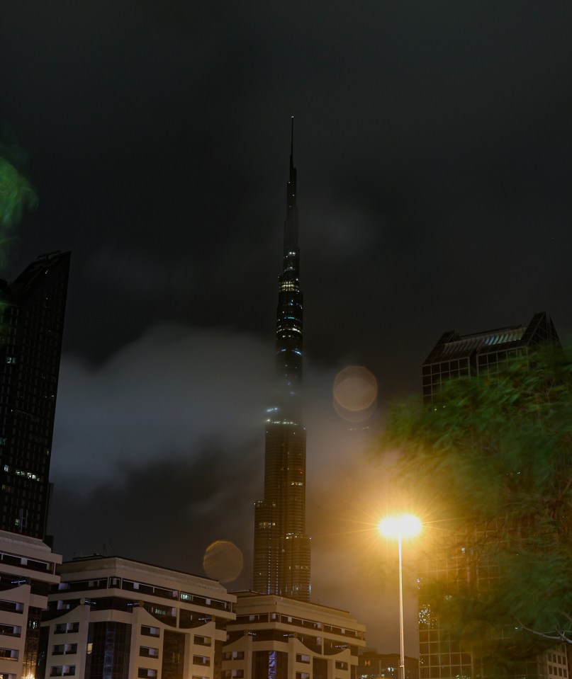 The world's tallest building Burj Khalifa is flanked by clouds in Dubai