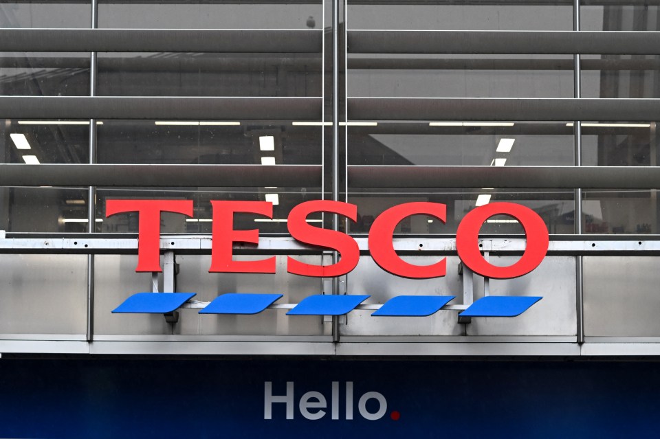 a large red tesco sign is above a blue hello sign