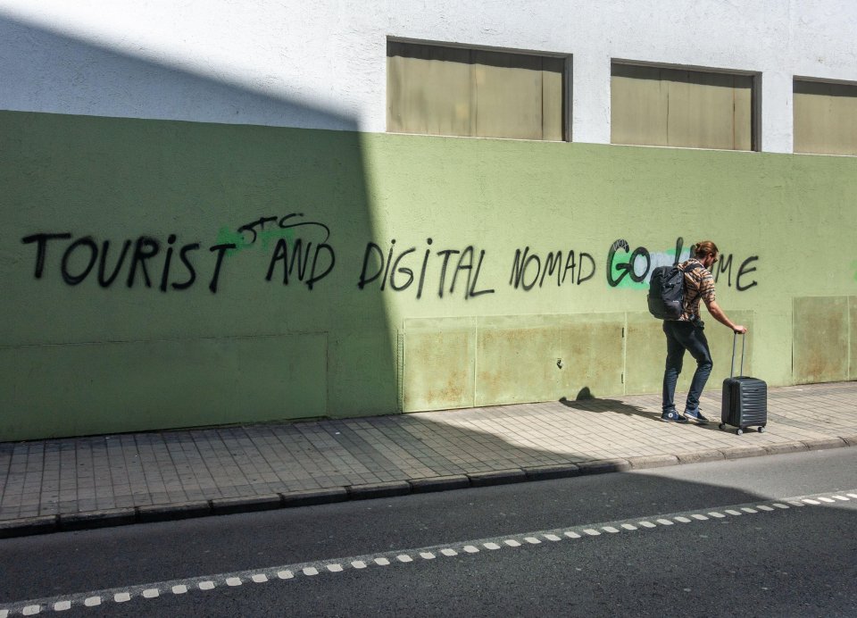 Another graffiti in Gran Canaria reads "tourist and digital nomad go home"