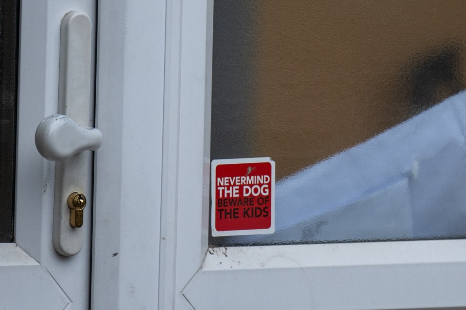 A sign on the property's door says: 'Nevermind the dog, beware of the kids.'