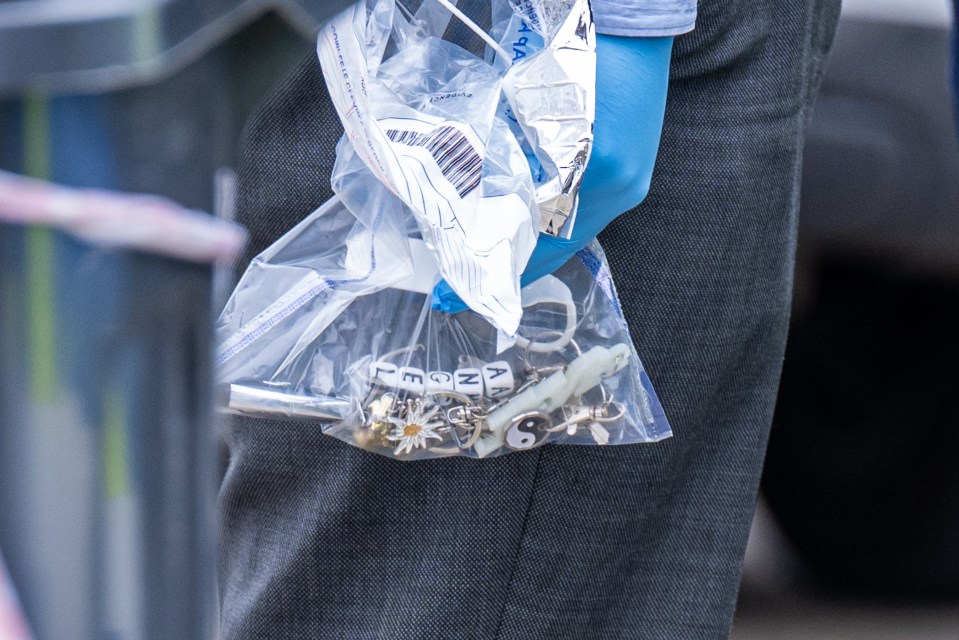 A bracelet with 'Angel' on it is removed from the property in an evidence bag