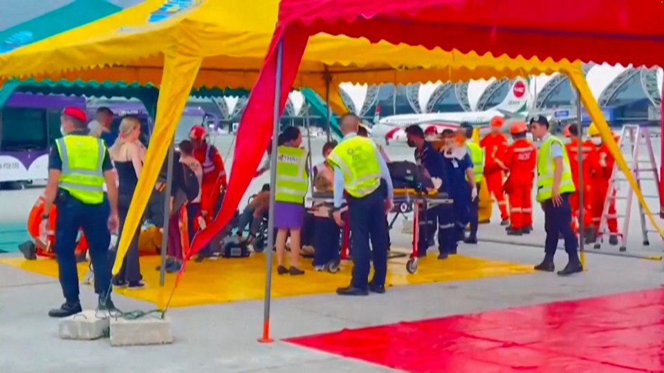 Rescue workers set up tents on the tarmac to treat the injured