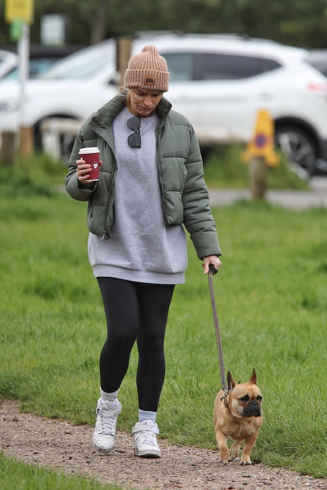 She had a grey jumper, beanie, coat, black joggers and white trainers for the walk