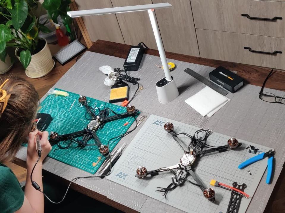 Zhanna soldiering together an attack drone inside her living room