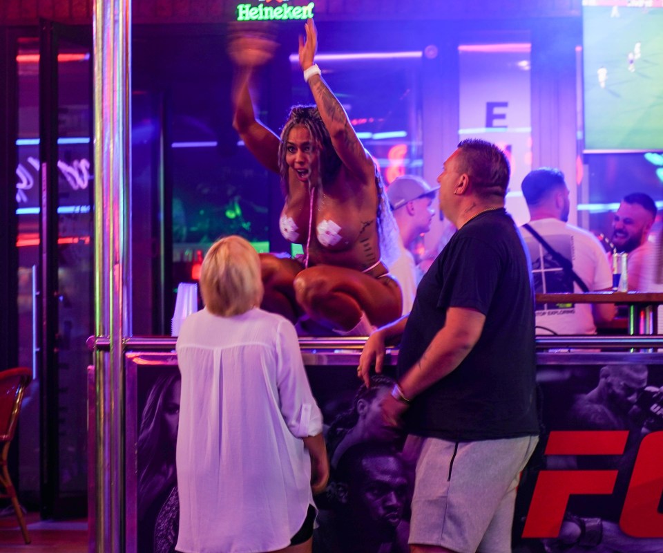 Revellers with a podium dancer at a club