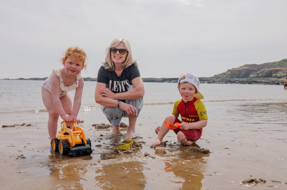 Sharon Mann with her grandkids enjoy playing in the sand in Tyneside