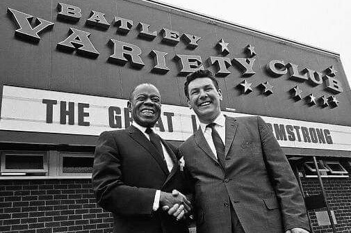 James shakes hands with Louis Armstrong outside his club