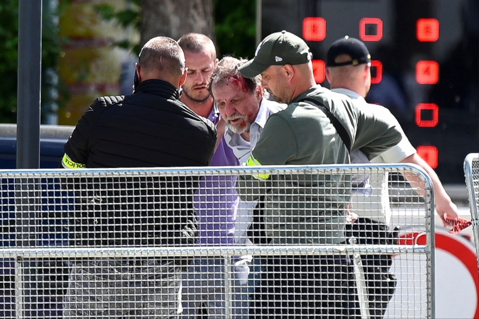 The suspected shooter was seen bloodied as he was dragged away by cops