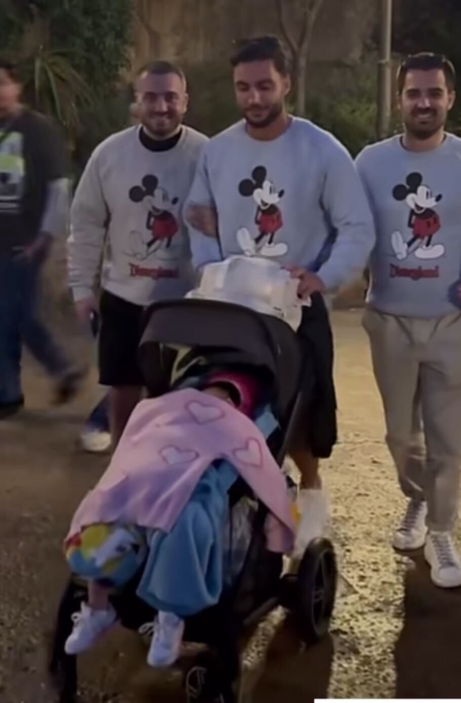 He pushed a pram around the park with pals as the mum filmed the group