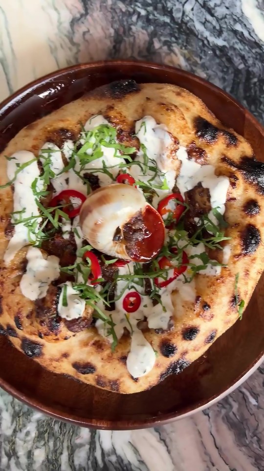 Restaurant Roe in London's Canary Wharf is flogging a vindaloo curry pizza — topped with snails