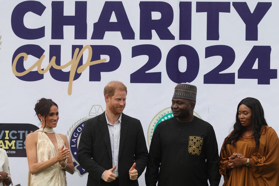 Britain's Meghan (L), Duchess of Sussex, Britain's Prince Harry (2ndL)), Duke of Sussex, Nigeria Chief of Defense Staff Christopher Musa (2ndR) and his wife Lilian Musa (R) pose for a photo after a charity polo game at the Ikoyi Polo Club in Lagos on May 12, 2024 as they visit Nigeria as part of celebrations of Invictus Games anniversary. (Photo by Kola Sulaimon / AFP) (Photo by KOLA SULAIMON/AFP via Getty Images)